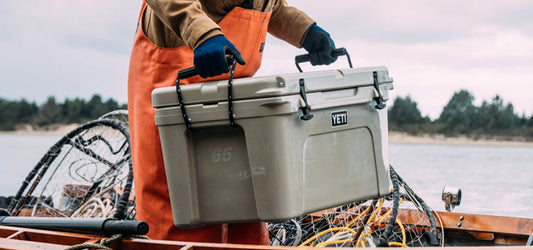 Fisherman Carrying Yeti Cooler Standing in Boat on Lake