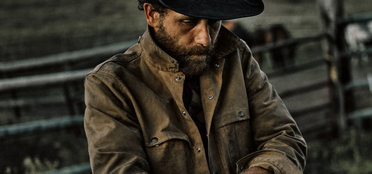 Hunters wearing Filson Tin Cloth jackets and durable outdoor clothing in rugged terrain, built for harsh weather conditions
