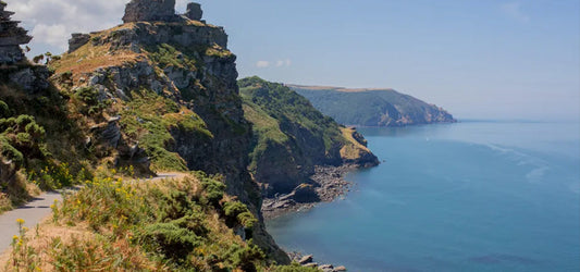 Clifftop walking path overlooking the North Devon coast with sea views and rugged headlands on a sunny summer day