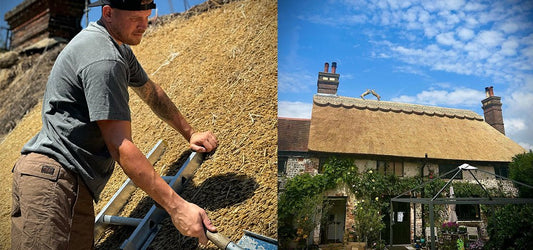 Thatcher Shane Stevens working on a traditional thatched roof, with a completed cottage showcasing his craftsmanship under a blue sky.