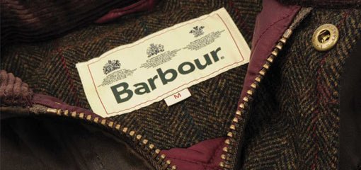 Barbour wax jacket label stitched inside tartan lining, showcasing heritage branding and quality craftsmanship