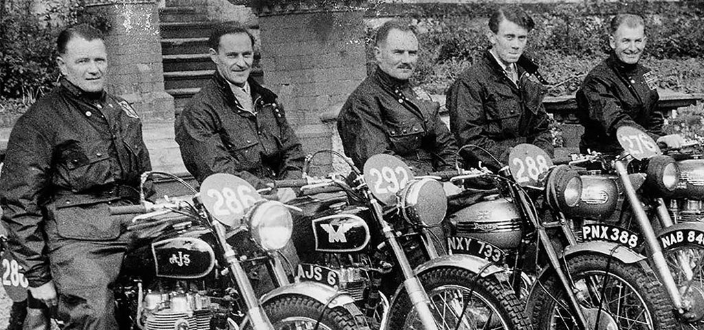 5 Men Sitting on Vintage Motorcycles wearing Classic Barbour Wax Jackets