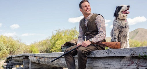 Hunter on Bridge Wearing Beretta Attire With Gun Dog