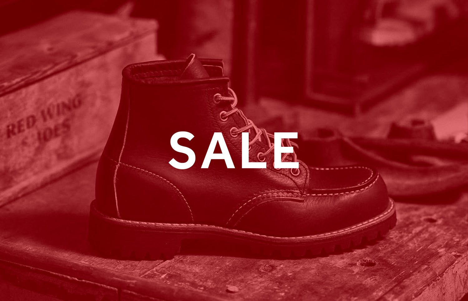 Black Red Wing boot with 'SALE' text on a red-themed background